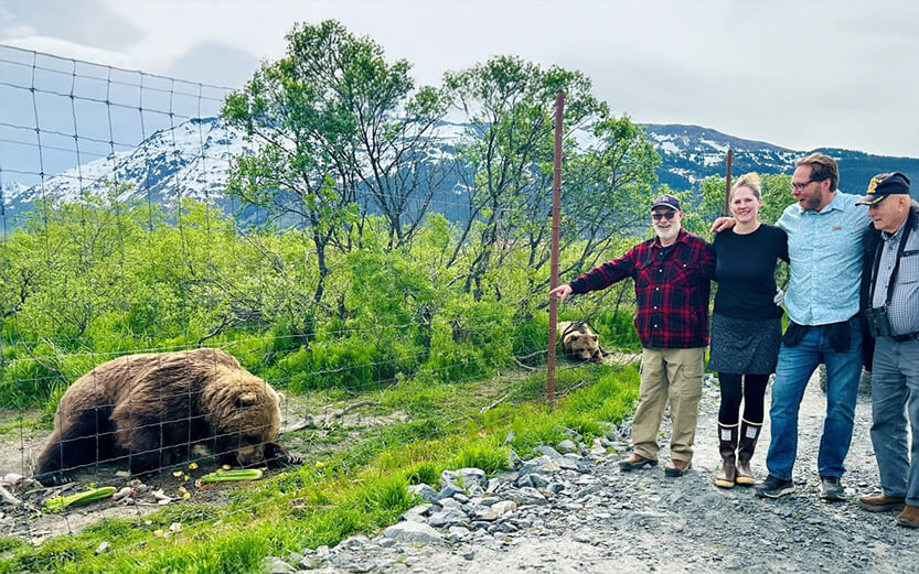 Guests participating in a brown bear feeding encounter at the Alaska Wildlife Conservation Center