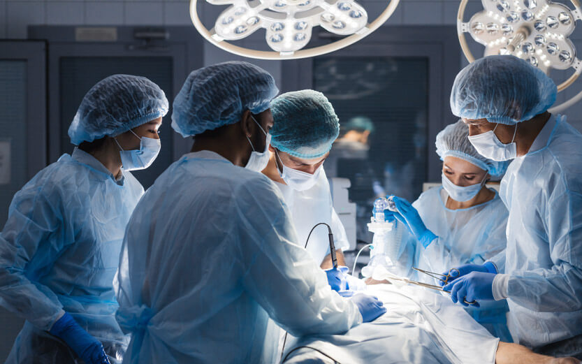 nurses and surgeons in an operating room