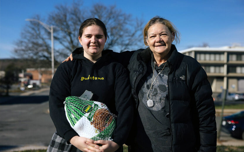 mother and daughter at a holiday turkey distribution event