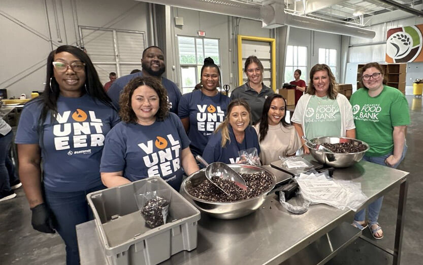 volunteers smiling and scooping cherries