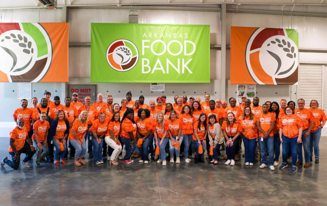 group portrait of foodbank workers inside the warehouse