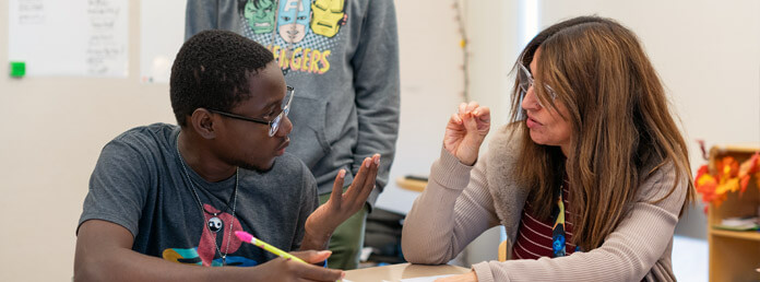 teacher signing with deaf student