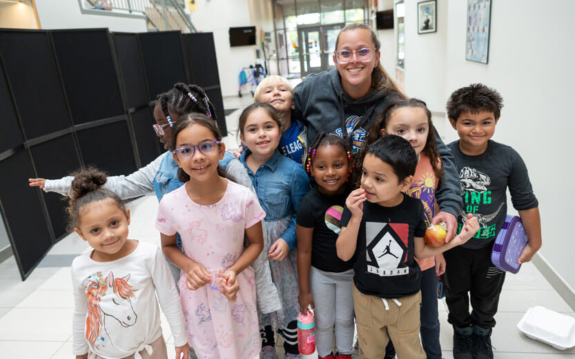 ASD teacher with students smiling