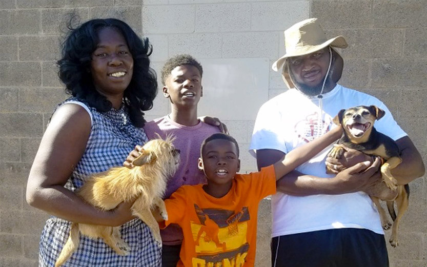 a family of four with their two small dogs