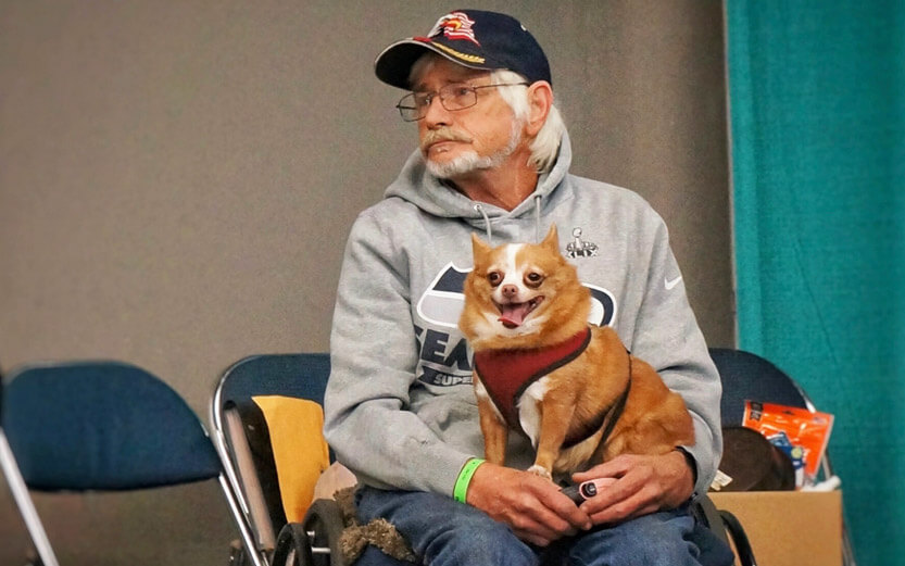 a disabled veteran with his dog in his lap