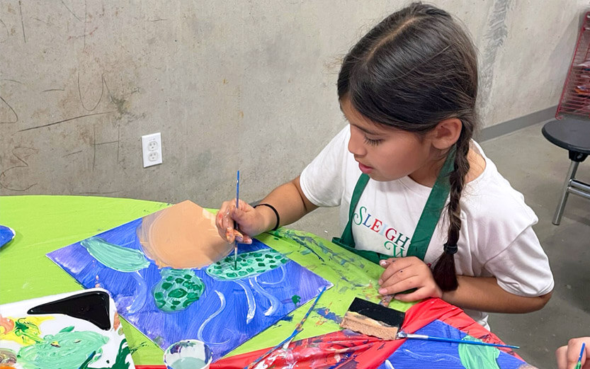 a young girl painting a sea turtle