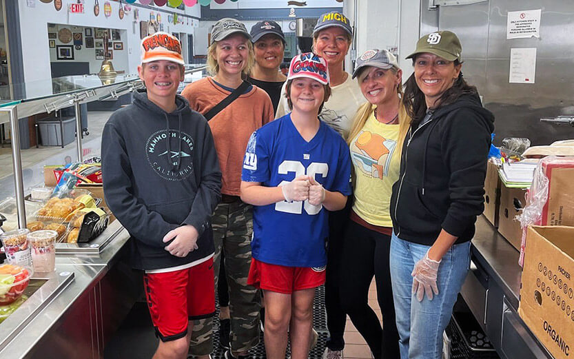 a group of young volunteers ready to work in the kitchen