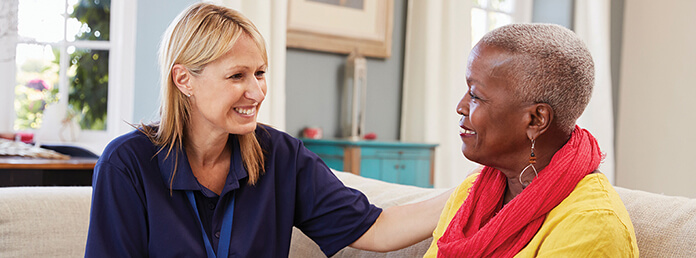 Female Support Worker Visits Senior Woman At Home