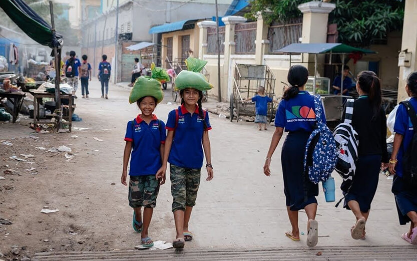 hildren walking in a community supported by the Cambodian Children's Fund, which provides resources like education and food to families in need