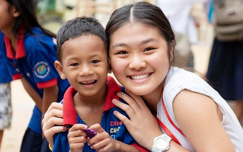 Cambodian Children's Fund logo on a blue school uniform