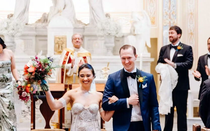 a happy couple walking down the aisle after getting married