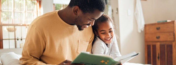 man reading to young girl
