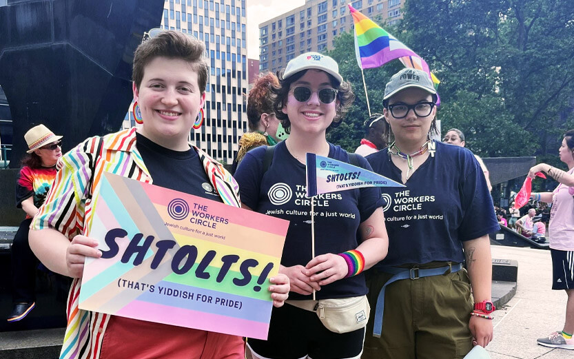 three people at a pride celebration