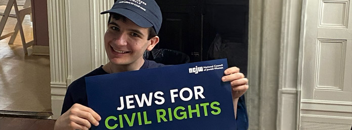 a teen boy holding a Jews for Civil Rights sign