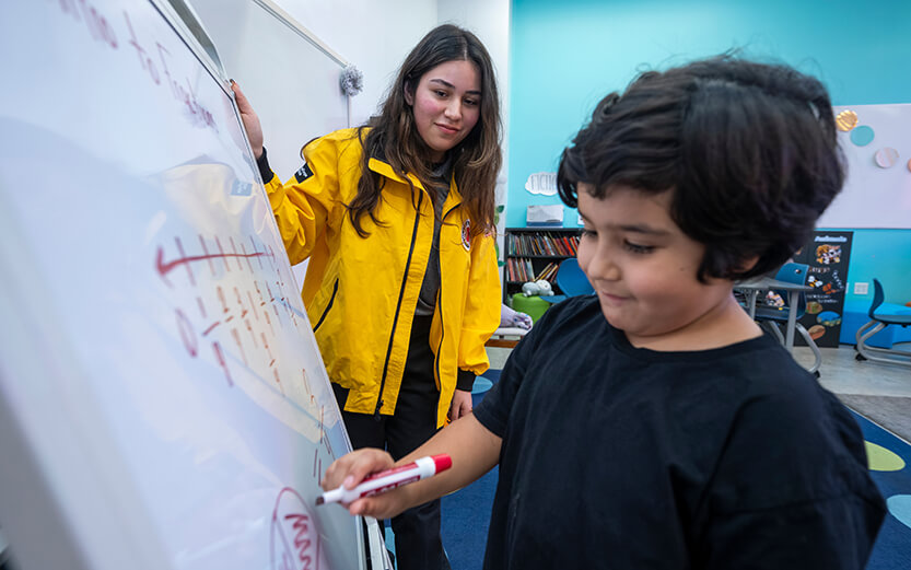 City Year person helping a child with learning