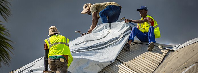 CORE tarps the home of Stashuana Burnette, President of the Middle Quarters Community Development Committee, who worked alongside CORE after Hurricane Beryl in 2024.