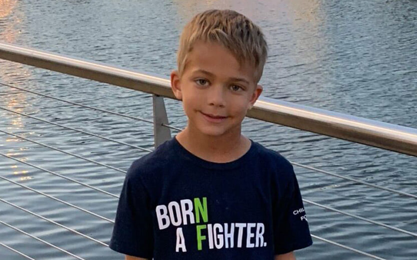 boy wearing a Born a Fighter tshirt