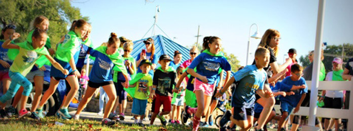group of children running at an event