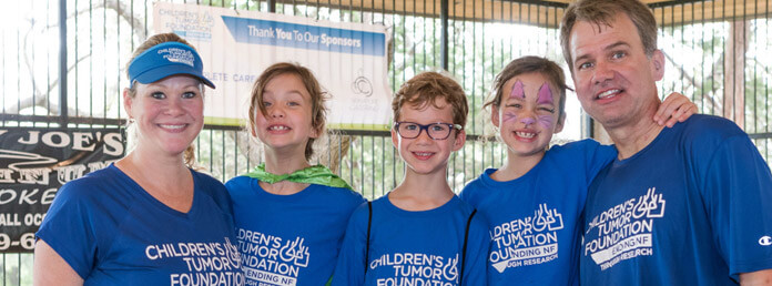 family wearing blue tshirts at a fundraising event