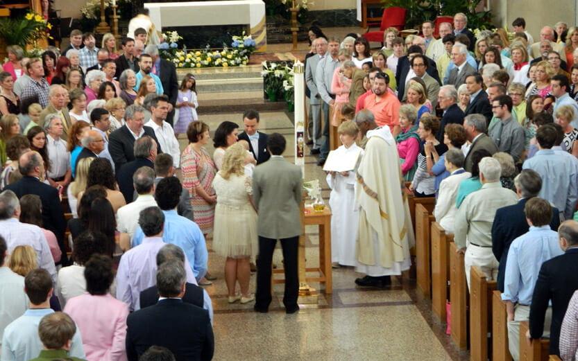 a baptism ceremony with the congregation looking on