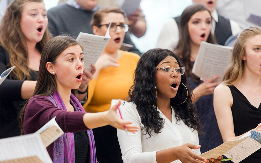 a group of women singing in choir class