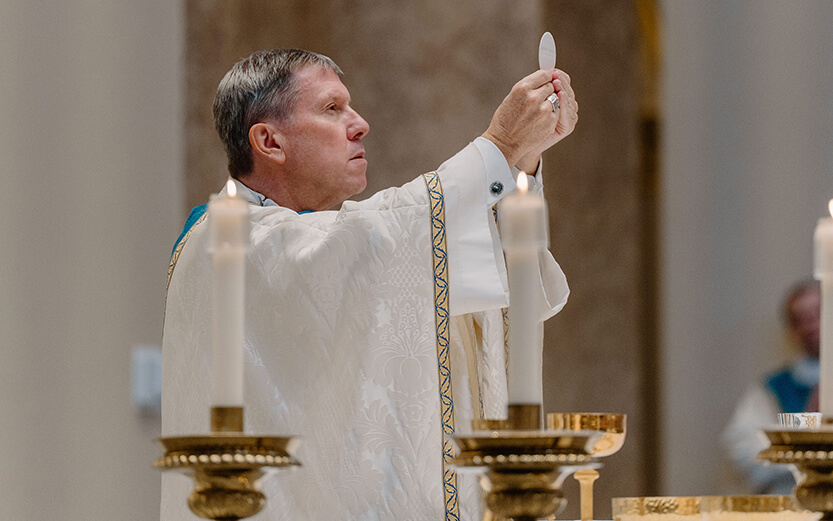 Bishop J. Mark Spalding of the Diocese of Nashville elevates the Eucharistic host during a Catholic Mass