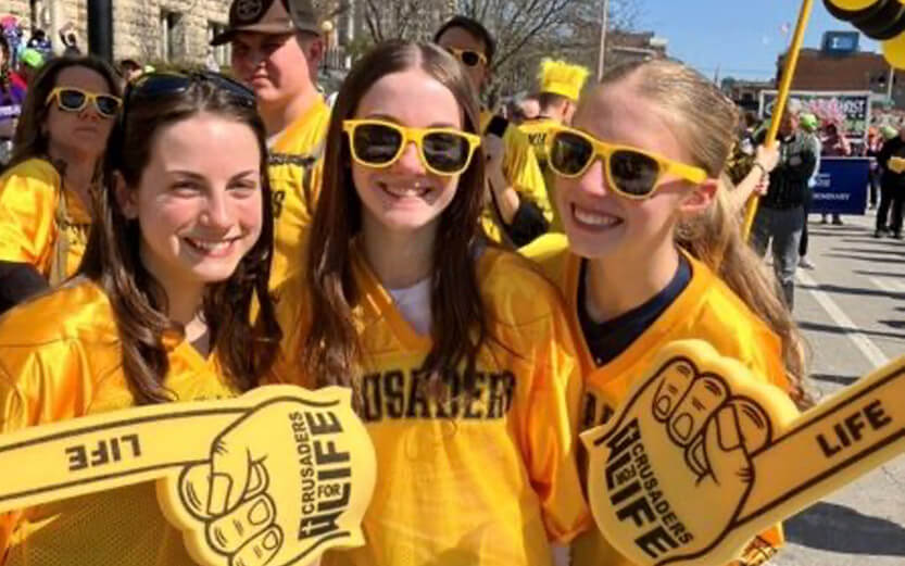 three teen girls at a pro life demonstration