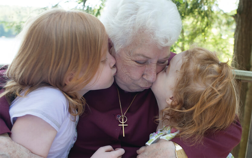 two children and a woman embracing