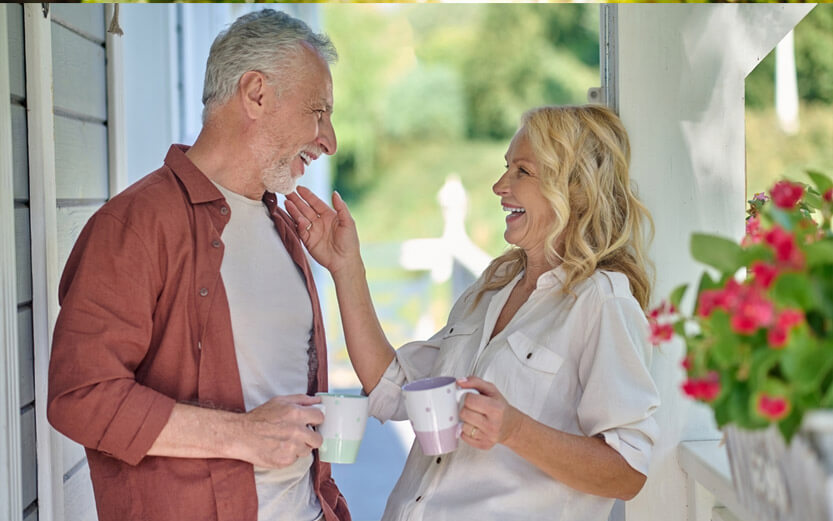 senior couple on the porch having coffee together