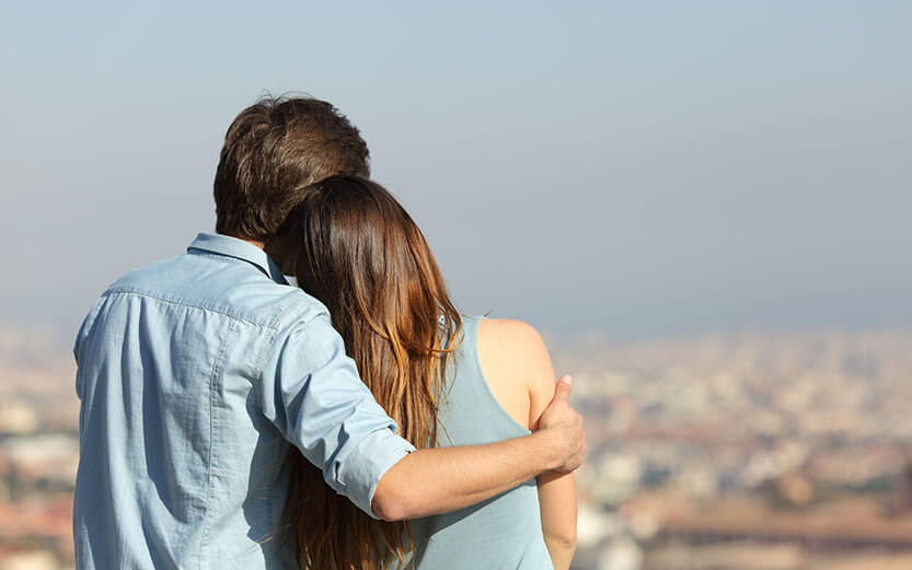 Happy couple dating contemplating the city