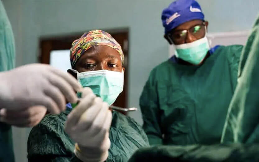 doctor in surgery holding surgical instrument