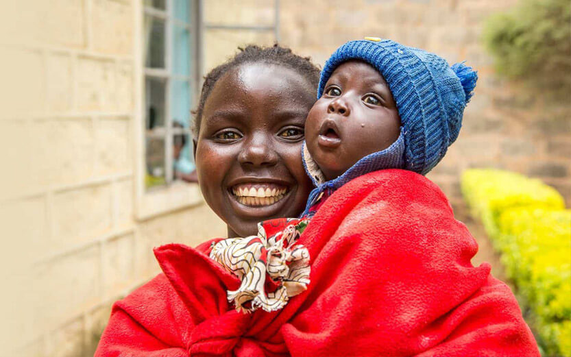 woman holding baby smiling