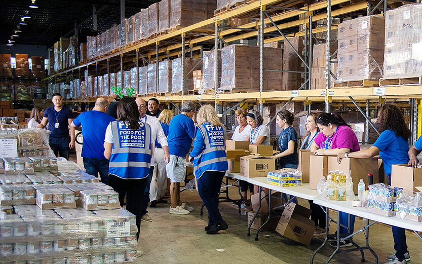 volunteers boxing food supplies in the FFTP warehouse