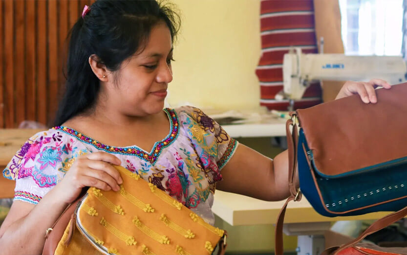 woman showing off the bags she's sewn