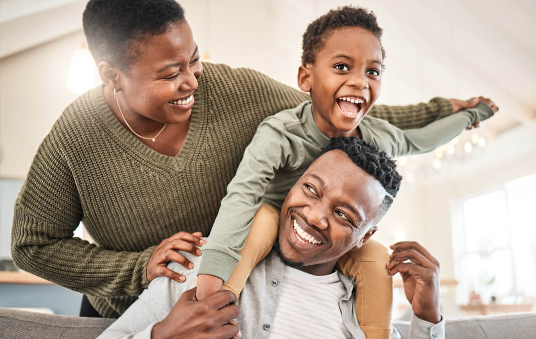 black family of three laughing together