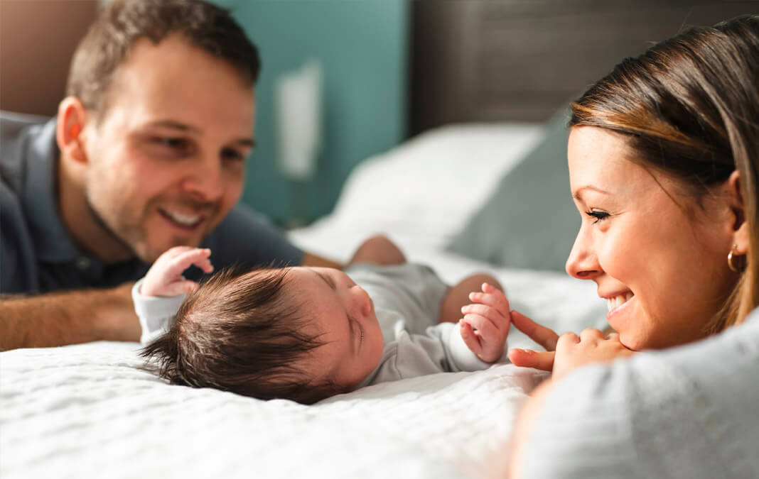 new parents looking at their newborn lovingly