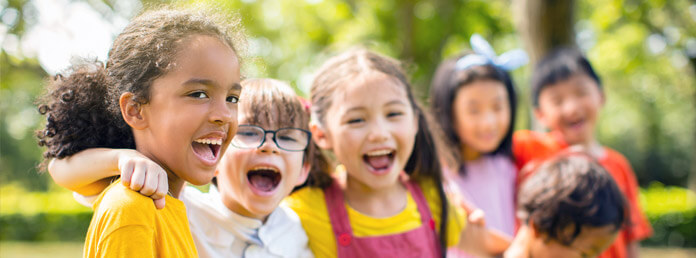 kids standing in a row outside laughing