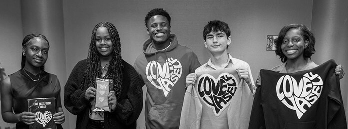 black and white image of five teens wearing Love Yaself sweatshirts