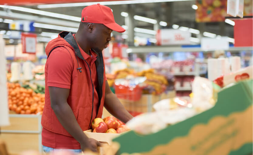 a man in a red shirt and a red hat in a store