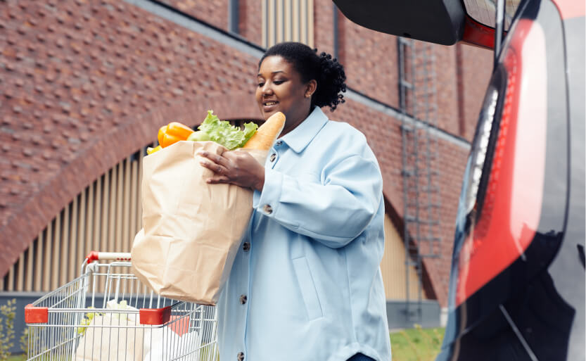 a woman holding a grocery bag