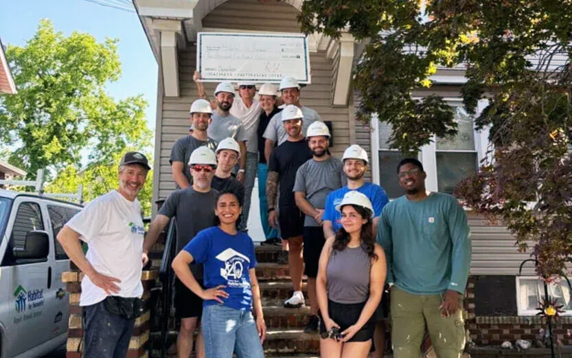 a group of construction volunteers posing for a photo