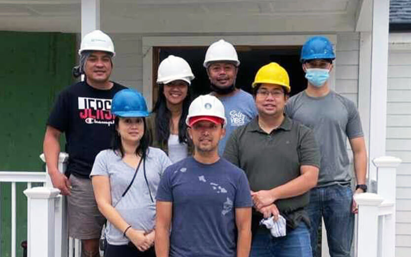 a group of construction volunteers posing for a photo