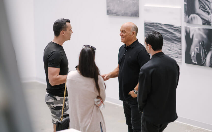 pastor greg laurie talking with three people