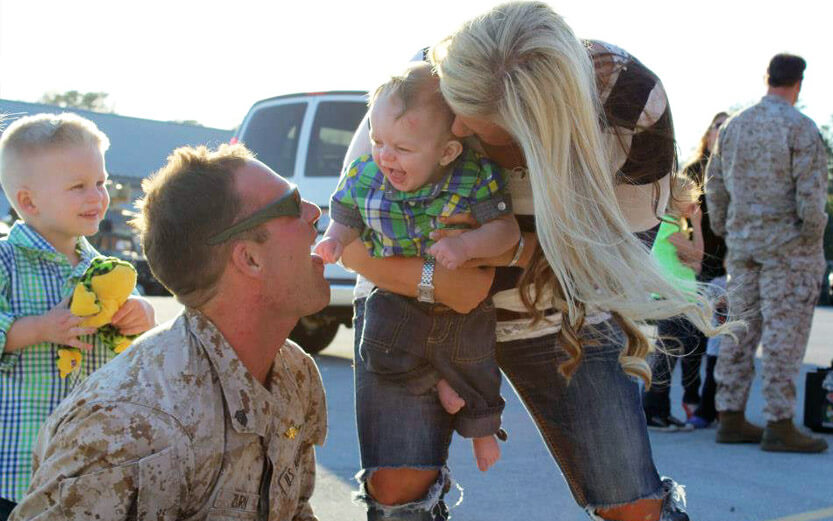 family of four laughing
