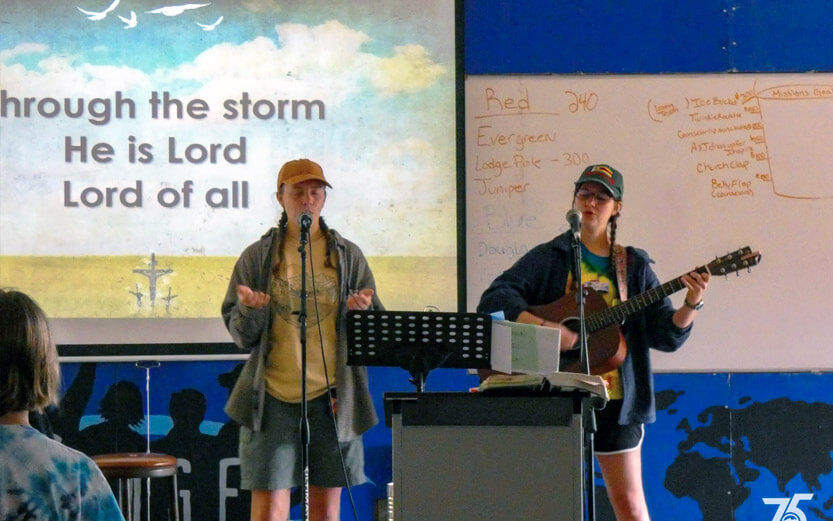 two camp counselors singing christian songs