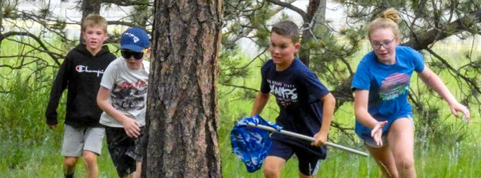 four campers playing Capture the Flag