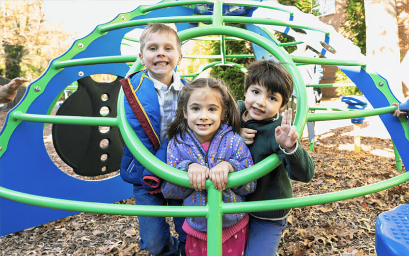 three preschoolers on the playground