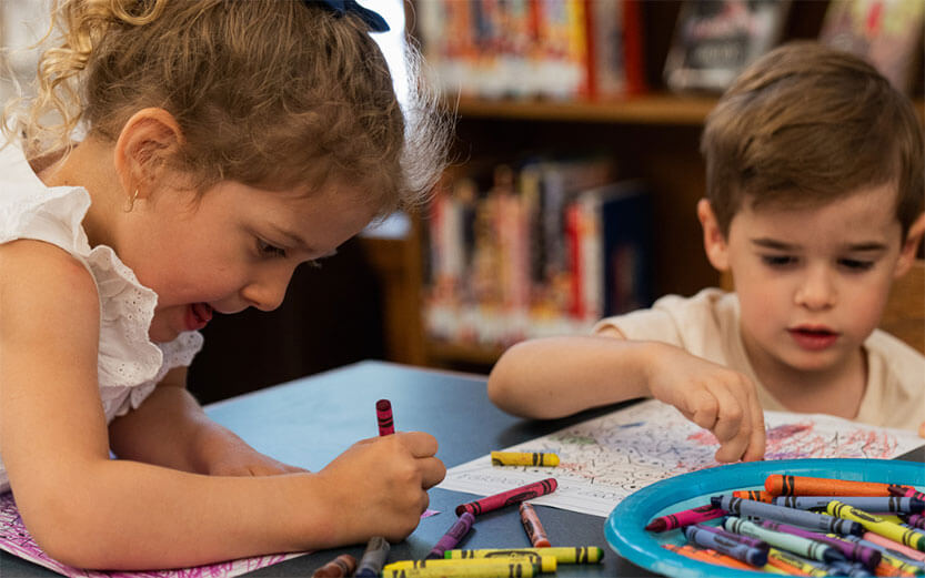 Preschoolers coloring at the Jersey City Free Public Library
