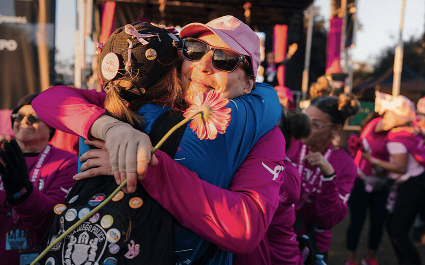 two women hugging at the end of a SGK walk