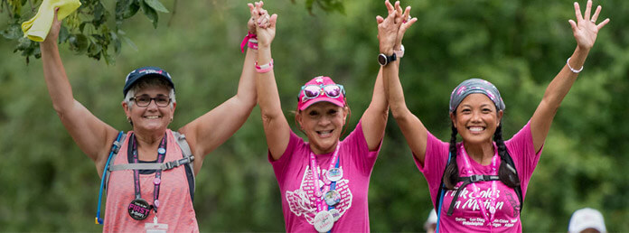 three women wearing pink tshirts during a fundraiser event